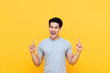 © Atstock Productions - Happy smiling young Asian man with hands poiting up