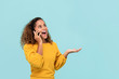Young African American woman happily talking to the phone
