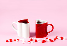 Two Heart Shape Mugs On Pink Background. Valentine's Day Concept.