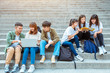 © Tom Wang - Group of students studying on the stairs  at campus