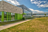 Fototapeta Zwierzęta - Elementary school building backside, a sunny spring day.
