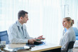 © visoot - The doctor is explaining the discomfort to the patient,Doctor and patient sitting in doctor's office.