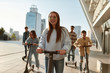 © Svitlana - More smiles per hour. A group of friends riding kick scooters and segways on a sunny day