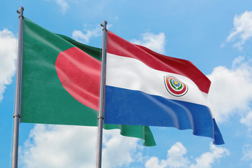 Paraguay and Bangladesh flags waving in the wind against white cloudy blue sky together. Diplomacy concept, international relations.