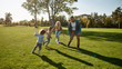 © Svitlana - Helping parents rest. Excited family running outdoors on a sunny day