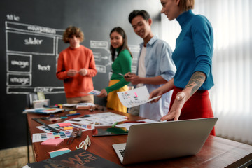 Wall Mural - perfect colour palette. group of four web designers in casual wear developing new web site layout an