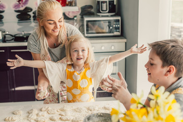 Wall Mural - Mom cooking with kids on the kitchen