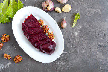 Wall Mural - Slices of boiled beets on a white plate. Source of energy. Dietary healthy vegetable. Top view.