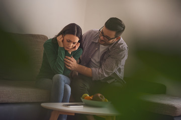 Wall Mural - Woman is sad, her man is consoling her.