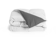 Folded Soft White Duvet, Blanket Or Bedspread With The Gray Back Side And Empty White Label, Against White Background. Close Up Photo