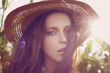 Beautiful young woman in a hat. Sunny lifestyle fashion portrait 