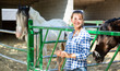 Happy woman horses breeder near stable