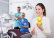 © JackF - Happy girl with apples in dental clinic
