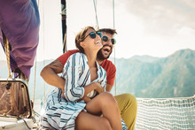 Loving Couple Spending Happy Time On A Yacht At Sea. Luxury Vacation On A Seaboat.