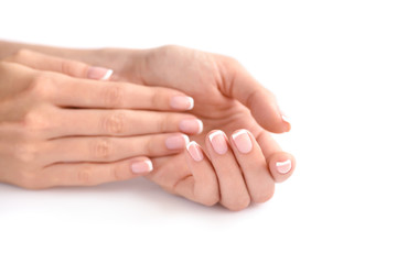 Wall Mural - Beautiful woman hands with french manicure on a white background