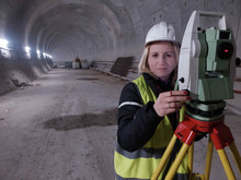 Female Mine Surveyor Works On Total Station In The Tunnel Under Construction
