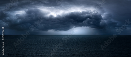 Fotomural dark and dramatic stormy clouds over sea