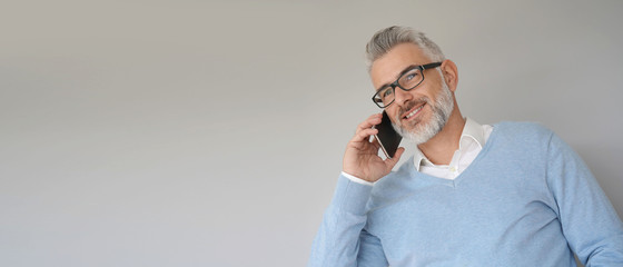 Wall Mural - Portrait of middle-aged man using smartphone, template