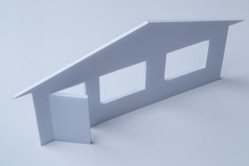 Poster - A model of the house stands on a white table. Large selection of apartments. Suitable accommodation for everyone. Design of premises. The acquisition of the cottages. Real estate mortgage.