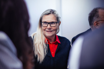 close up. senior businesswoman sitting among her colleagues .