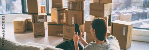 Fotografía Moving boxes woman using phone panoramic for move to college leaving apartment ready for movers pick-up with packages of cardboard box for new home move in