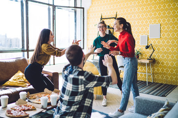 Wall Mural - Excited friends having conversation together at house party