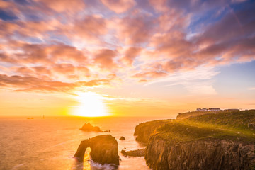 Wall Mural - Dramatic sky at sunset with Enys Dodnan and the Armed Knight rock formations at Lands End