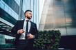 © BullRun - Happy successful executive man on street in city