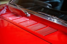 Grill Under Windshield On Hood Of Red Classic Car