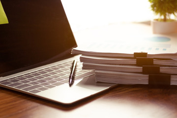 Stack of documents placed on a business desk in a business office.