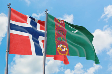 Turkmenistan and Bouvet Islands flags waving in the wind against white cloudy blue sky together. Diplomacy concept, international relations.