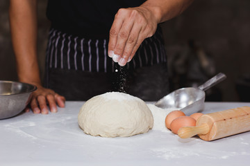 The chef is spinning the dough in the kitchen