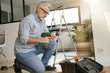 © goodluz - Man at home using electric drill, do-it-yourself work