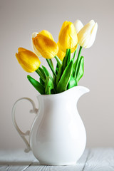 Wall Mural - bouquet of spring tulips on a bright background. greeting card.