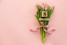 Wooden Cube Calendar Showing 8th Of March Date, The International Women's Day Holiday With Beautiful Pink Tulip Flowers Bouquet. Close Up, Copy Space, Background. Holiday Greeting Concept.