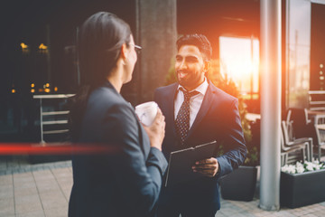 Stylish business partners speaking together in street in downtown