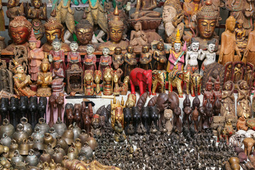 Wall Mural - A lot of bright souvenirs on the counter of the ancient souvenir market in Myanmar