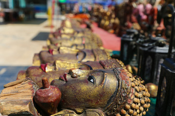 Wall Mural - A lot of bright souvenirs on the counter of the ancient souvenir market in Myanmar