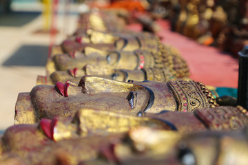 Wall Mural - A lot of bright souvenirs on the counter of the ancient souvenir market in Myanmar