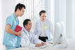 © DragonImages - Medical workers gathered in front of computer in office to discussing difficult case