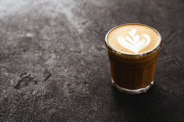 Poster - Cup of coffee on black stone background Top view