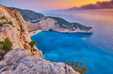 Fototapeta Most - Navagio Beach with shipwreck view on Zakynthos island, Greece. Incredibly romantic sunrise on Zakinthos. Amazing sunset view with multicolored clouds. Island of lovers. Doors to heaven
