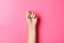 Woman Hand With Red Nails On Pink Background, Space For Text