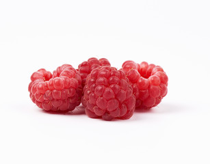 Wall Mural - whole ripe red raspberries on a white background