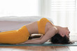 Beautiful Attractive Asian woman practice yoga Fish or yoga Matsyasana pose to meditation with yoga in bedroom,Recreation in holidays concept