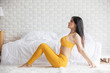 © 220 Selfmade studio - Happy Athletic Asian woman practice yoga stretching pose for stretching muscle for warm up with meditation smile after wake up in the morning Feeling so comfortable and relax,Healthcare Concept