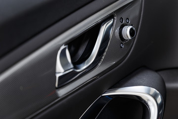 Wall Mural - Car interior. Car door interior trim. Soft focus. Modern car illuminated dashboard. Luxurious car instrument cluster. Close up shot of automobile instrument panel. Modern car interior dashboard