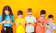 © oksix - Group of kids using digital mobile phone