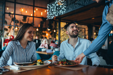 Wall Mural - romantic couple in restaurant having lunch