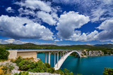 Sunlight view on the Sibenik Bridge a long concrete arch bridge passing through the canyon of the Krka River. Location Skradin town, Croatia, Europe. Travel destination. Discover the beauty of earth